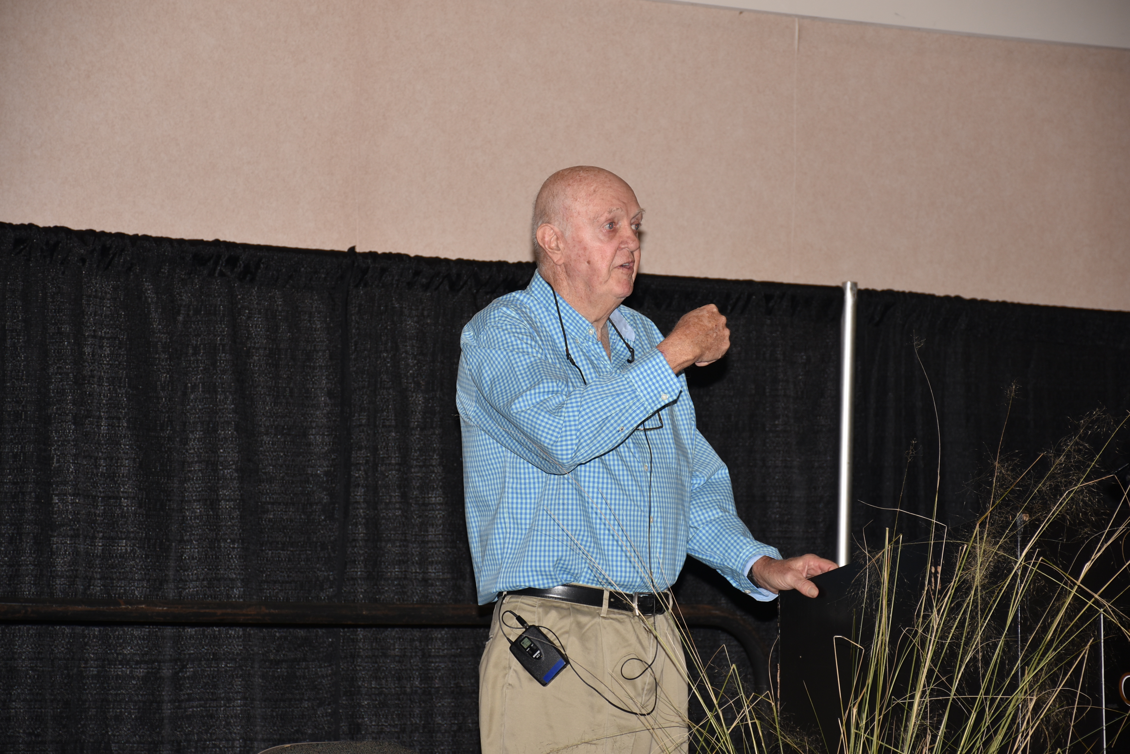 Man speaking from podium.JPG thumbnail
